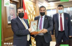 Handing a sponsorship shield to Al-Balqa Applied University