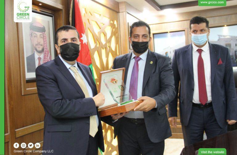 Handing a sponsorship shield to Al-Balqa Applied University